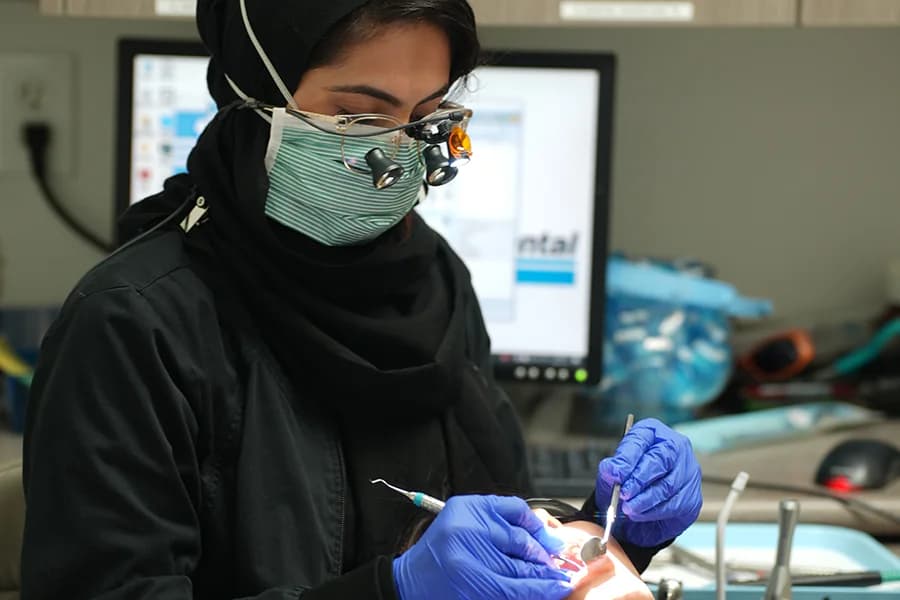 Emergency dentist performing dental work